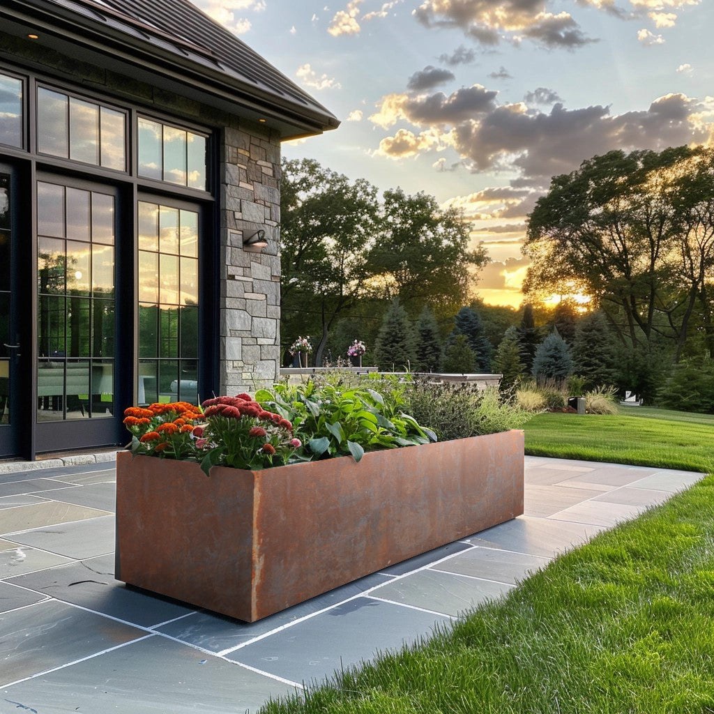Metal planter and modern house. Long power coated rectangular steel planter thick gauge high quality welded in America USA made craftsman bespoke in the backyard of a modern farmhouse. Rusted metal planter stone house.